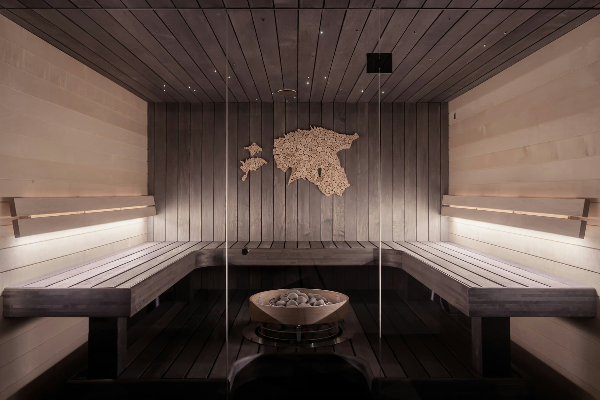 Warm, wood-lined relaxation room with soft ambient lighting
