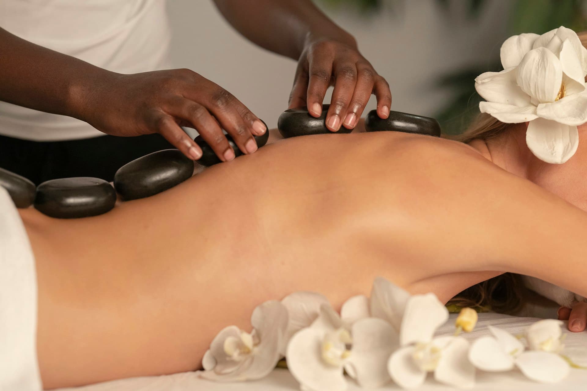 Hot stone massage with warm basalt stones placed along the back